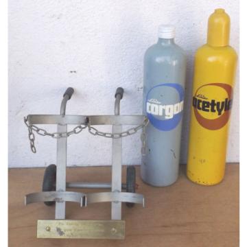 Linde Acetylene/Corgon Schnapps bottles on hand trucks - Decorational object